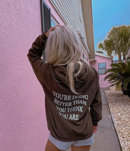 gildan chocolate brown 50% cotton and 50% polyester hoodie with inspirational christian quote on the back. You're doing better than you think you are quote like trendy Pinterest and VSCO hoodies and sweatshirts